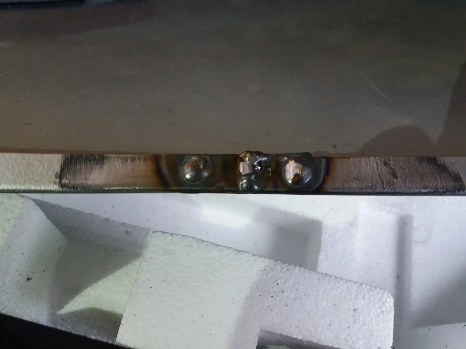 Thin metal with rust spot.